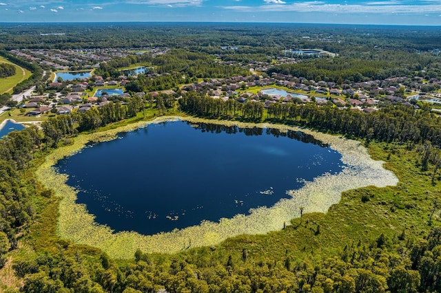 aerial view featuring a wooded view and a water view