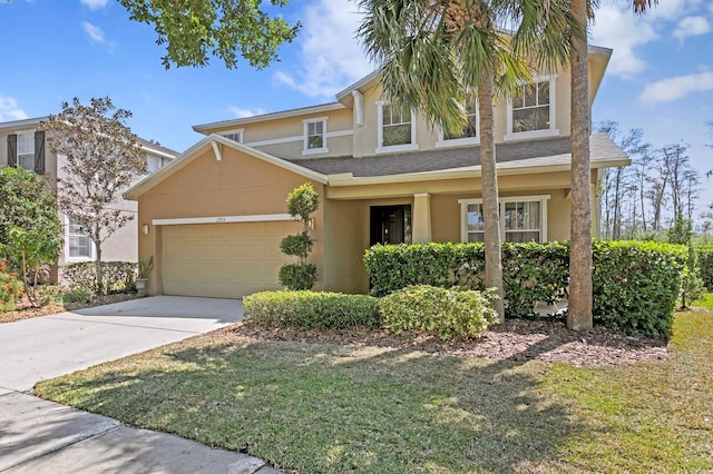 view of front of home with stucco siding, an attached garage, and concrete driveway