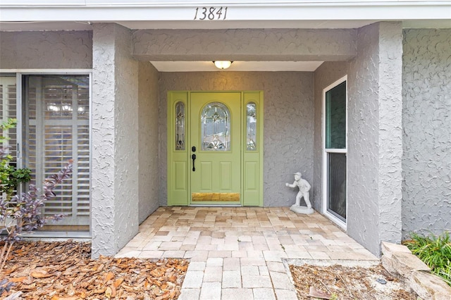 property entrance featuring stucco siding