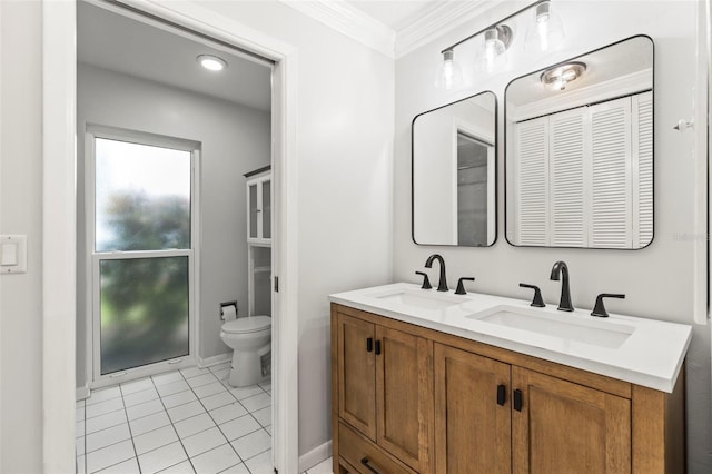 bathroom with toilet, crown molding, a sink, and tile patterned flooring