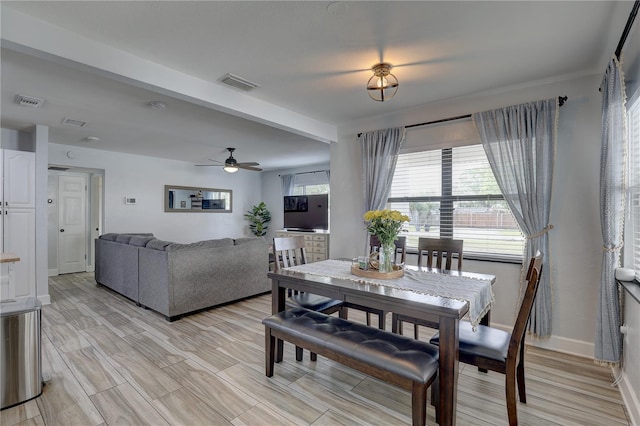 dining space featuring baseboards, ceiling fan, visible vents, and light wood finished floors
