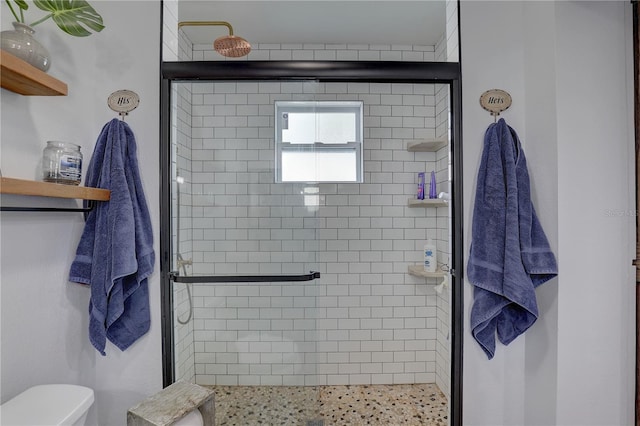 full bath with toilet and a stall shower