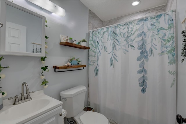 bathroom with vanity, toilet, and curtained shower