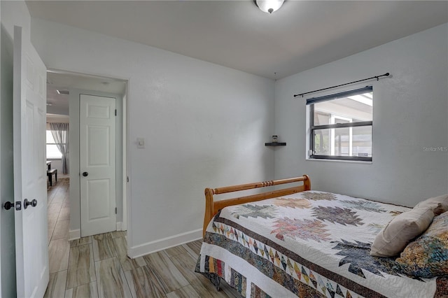 bedroom with multiple windows and baseboards