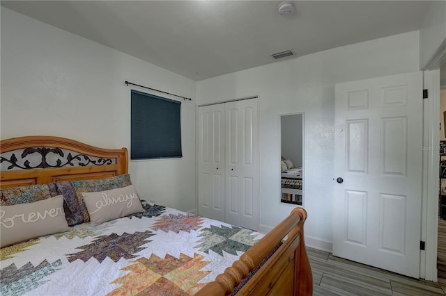 bedroom with visible vents and a closet