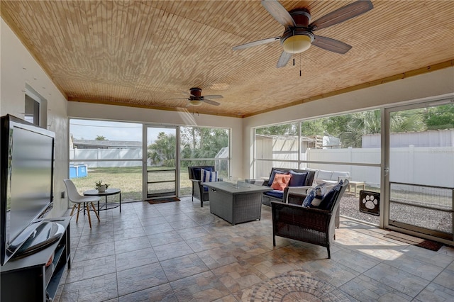 sunroom / solarium with an outdoor hangout area and a ceiling fan