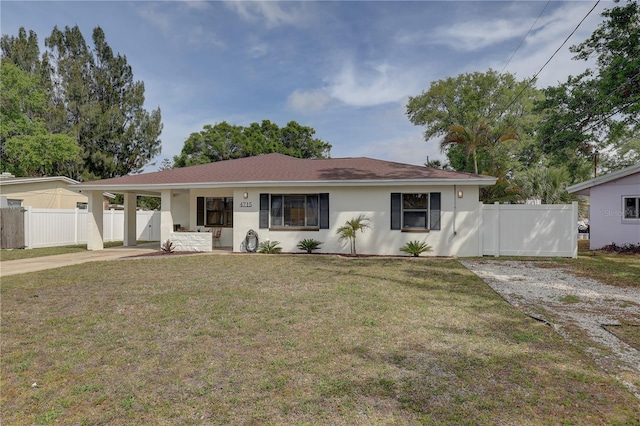 single story home with fence, stucco siding, an attached carport, a front lawn, and driveway