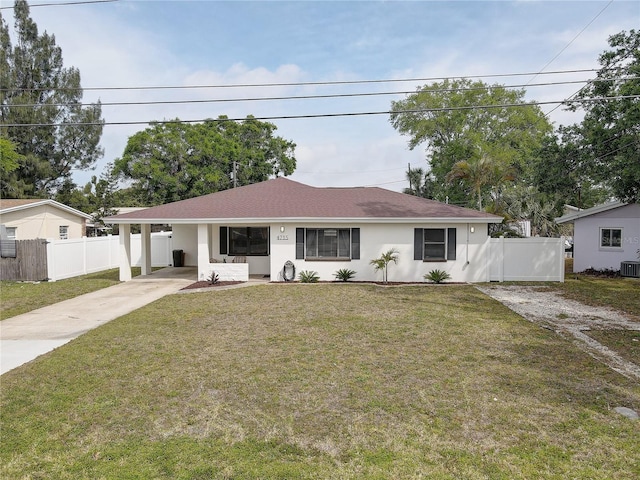 ranch-style house featuring driveway, a carport, a front yard, and fence