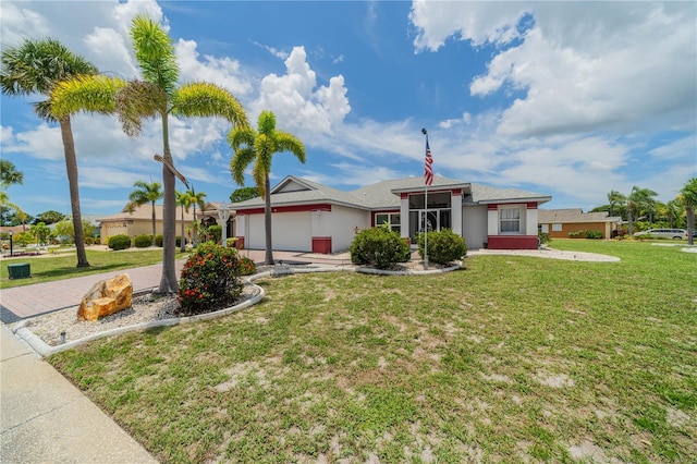 301 Caloosa Palms Ct, Sun City Center, FL 33573 - ranch-style home with a garage, a front lawn, driveway, and stucco siding