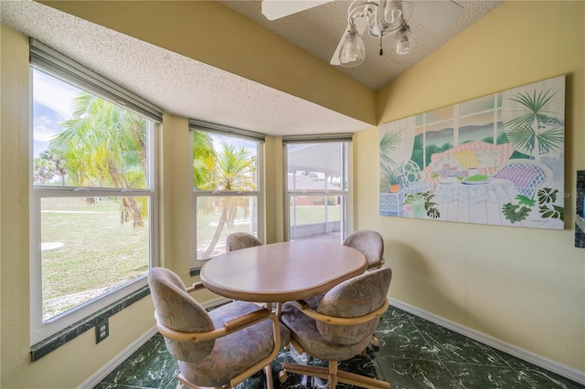 301 Caloosa Palms Ct, Sun City Center, FL 33573 - dining room with marble look tile flooring, a ceiling fan, healthy amount of natural light, lofted ceiling, and a textured ceiling