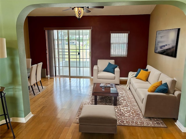 301 Caloosa Palms Ct, Sun City Center, FL 33573 - living area with arched walkways, a ceiling fan, and wood finished floors