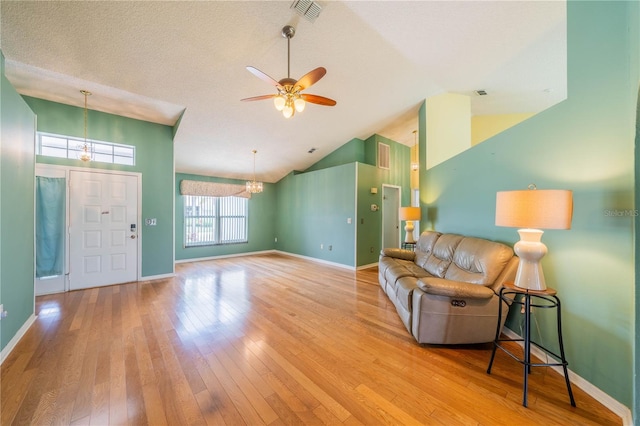 301 Caloosa Palms Ct, Sun City Center, FL 33573 - living area featuring a ceiling fan, hardwood / wood-style floors, a chandelier, and high vaulted ceiling