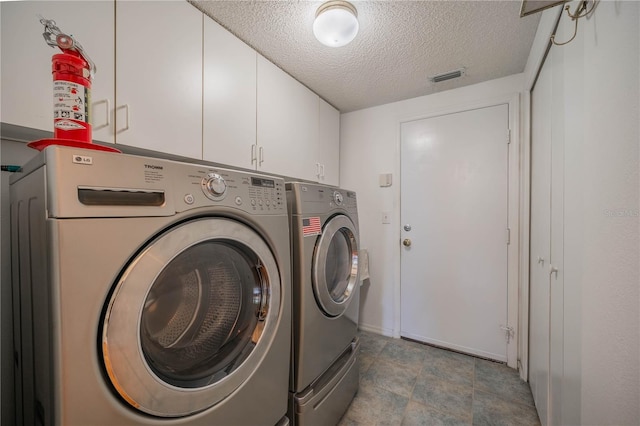 301 Caloosa Palms Ct, Sun City Center, FL 33573 - washroom with washer and clothes dryer, cabinet space, and a textured ceiling