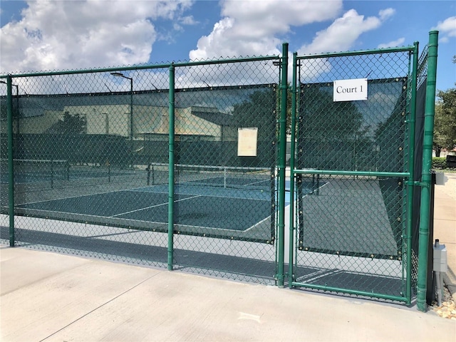 301 Caloosa Palms Ct, Sun City Center, FL 33573 - view of tennis court featuring a gate