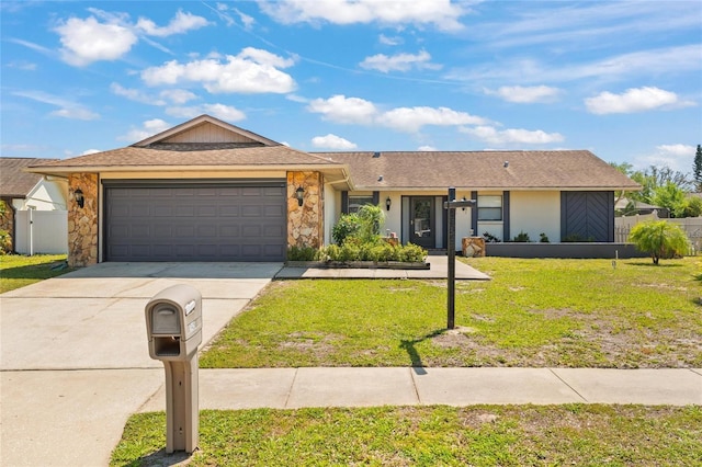 ranch-style house with fence, stone siding, a front lawn, an attached garage, and driveway