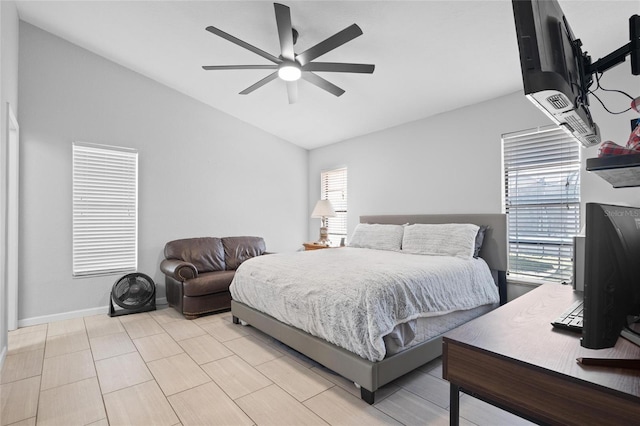 bedroom featuring baseboards, a ceiling fan, and vaulted ceiling