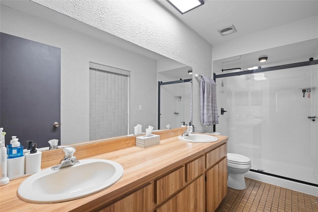 full bathroom with a shower stall, visible vents, and a sink