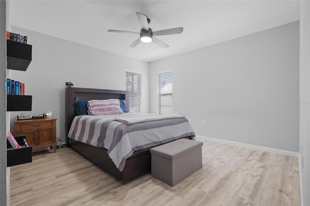 bedroom with baseboards, light wood finished floors, and ceiling fan