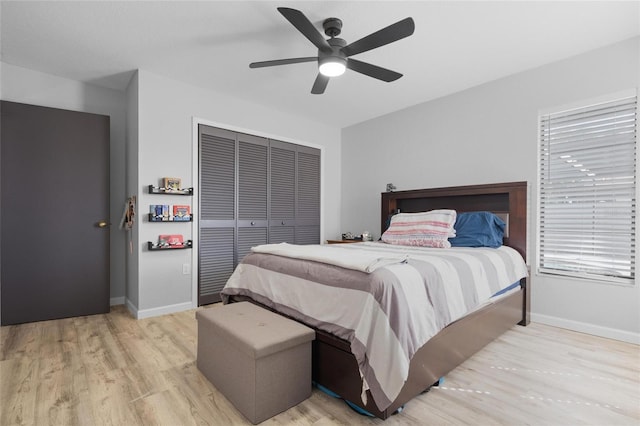 bedroom featuring a closet, light wood finished floors, and baseboards