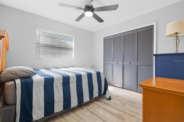 bedroom featuring a closet, light wood finished floors, and ceiling fan