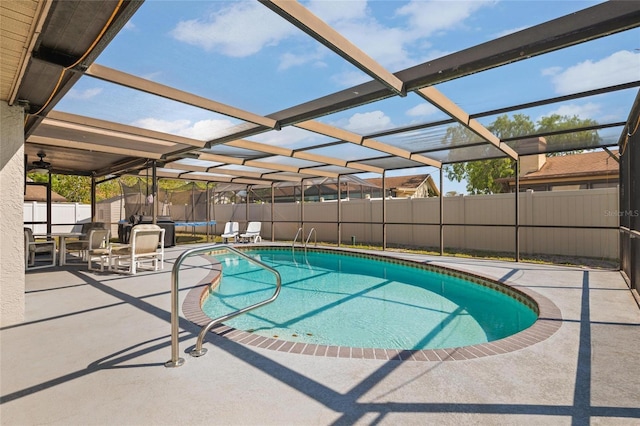 view of pool with a patio area, a trampoline, a fenced backyard, a fenced in pool, and a lanai