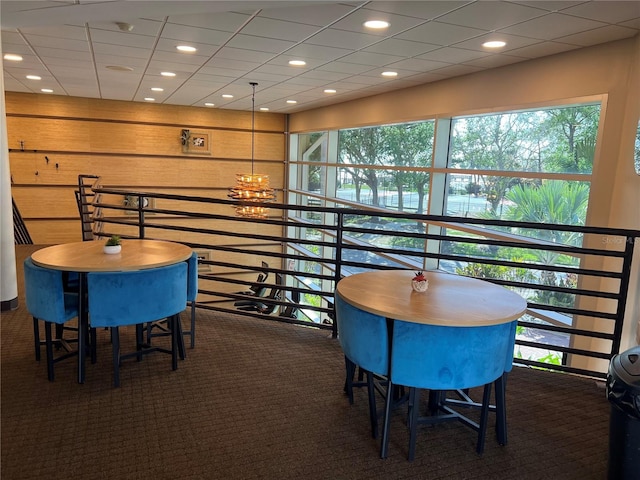 carpeted dining room with a notable chandelier and recessed lighting