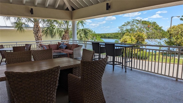 view of patio featuring an outdoor hangout area, a balcony, and a water view
