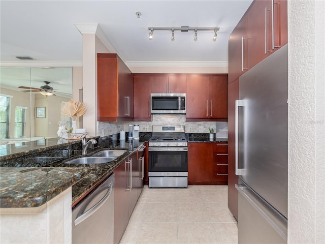 2709 Via Cipriani Unit 522B, Clearwater, FL 33764 - kitchen with light tile patterned floors, a sink, crown molding, stainless steel appliances, and decorative backsplash