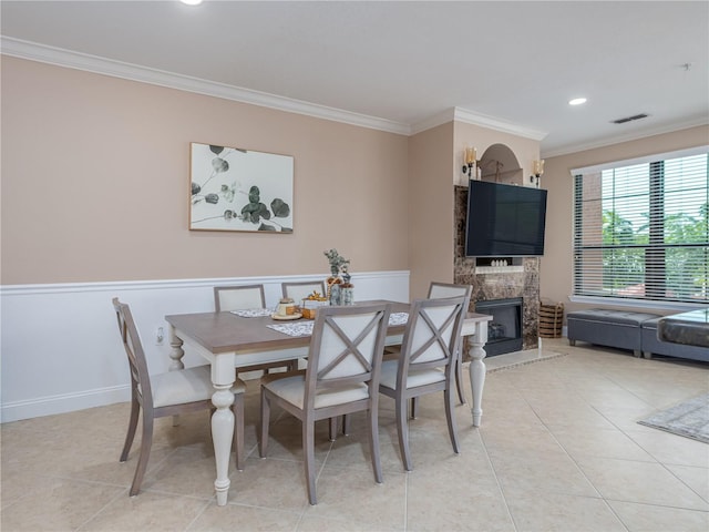 2709 Via Cipriani Unit 522B, Clearwater, FL 33764 - dining room featuring a high end fireplace, visible vents, ornamental molding, and light tile patterned flooring
