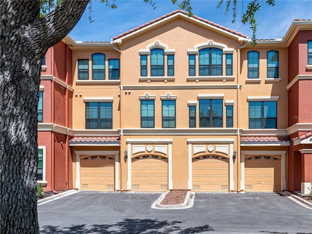 2709 Via Cipriani Unit 522B, Clearwater, FL 33764 - multi unit property featuring a garage, stucco siding, and driveway
