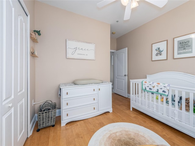 2709 Via Cipriani Unit 522B, Clearwater, FL 33764 - bedroom with light wood-style flooring, baseboards, a ceiling fan, and a nursery area