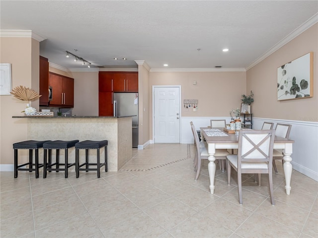2709 Via Cipriani Unit 522B, Clearwater, FL 33764 - dining area featuring crown molding, light tile patterned floors, baseboards, and recessed lighting