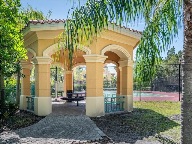2709 Via Cipriani Unit 522B, Clearwater, FL 33764 - view of property's community with a tennis court and fence