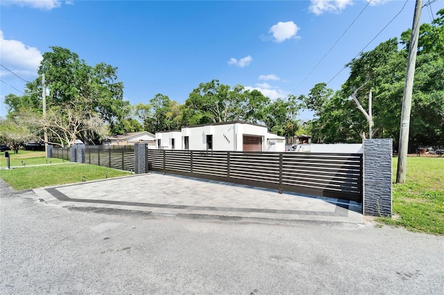 view of gate featuring a fenced front yard and a yard