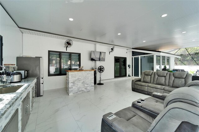 living area featuring marble finish floor and recessed lighting