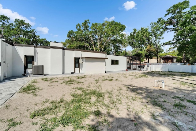 exterior space featuring central air condition unit and fence