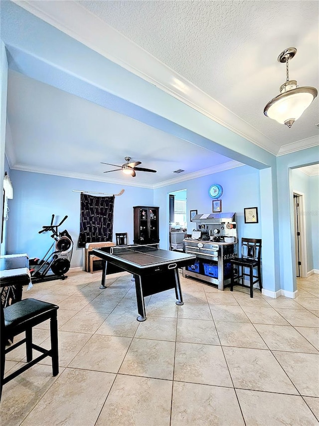 game room with light tile patterned floors, baseboards, crown molding, and a textured ceiling