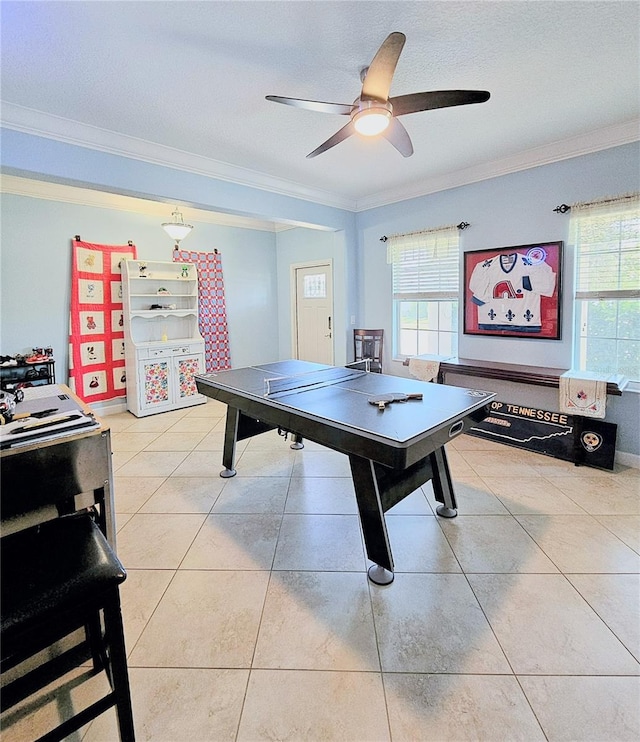 rec room featuring plenty of natural light, ornamental molding, a ceiling fan, and light tile patterned flooring