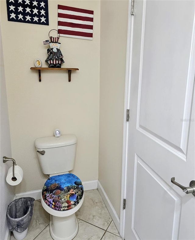 bathroom featuring baseboards and toilet