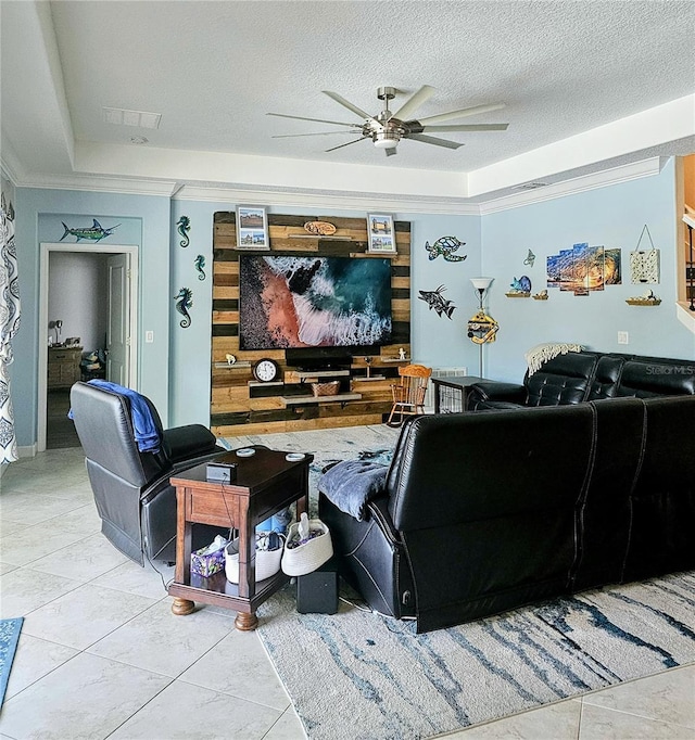 interior space with crown molding, a tray ceiling, ceiling fan, and a textured ceiling