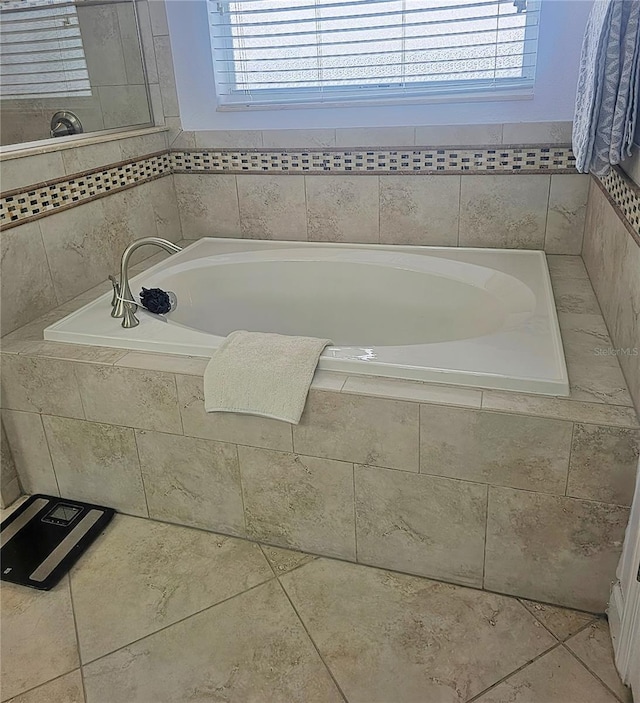 full bathroom with a bath and plenty of natural light