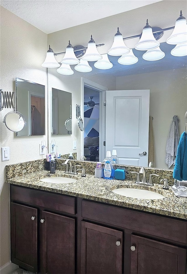 full bath with double vanity and a sink