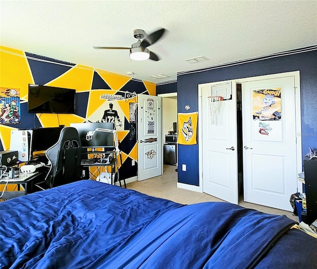carpeted bedroom with visible vents, a textured ceiling, and baseboards