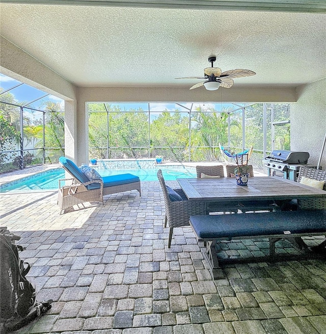 view of patio / terrace featuring a grill, ceiling fan, glass enclosure, outdoor dining area, and an outdoor pool