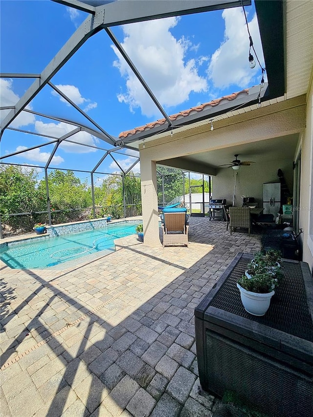 outdoor pool featuring a patio, a lanai, and ceiling fan