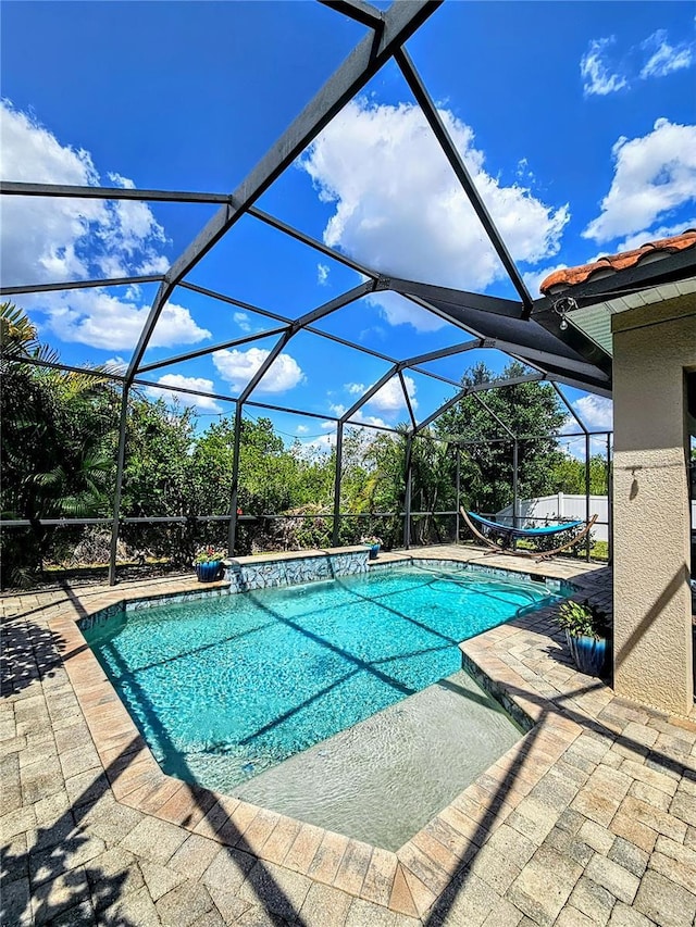 outdoor pool with a patio and a lanai