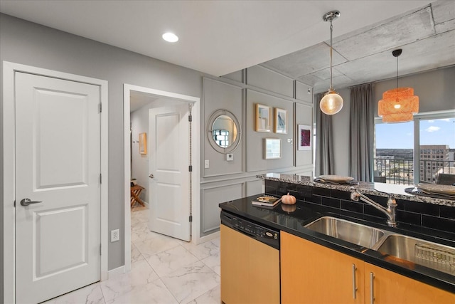 kitchen featuring a sink, hanging light fixtures, dishwashing machine, marble finish floor, and dark countertops