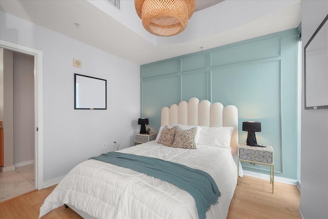 bedroom featuring baseboards and light wood-style flooring