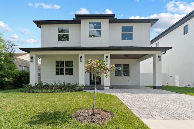 806 W Adalee St, Tampa, FL 33603 - view of front facade featuring brick siding, decorative driveway, a front lawn, and board and batten siding
