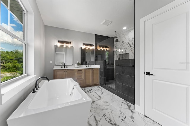 806 W Adalee St, Tampa, FL 33603 - bathroom with a stall shower, marble finish flooring, double vanity, a soaking tub, and recessed lighting